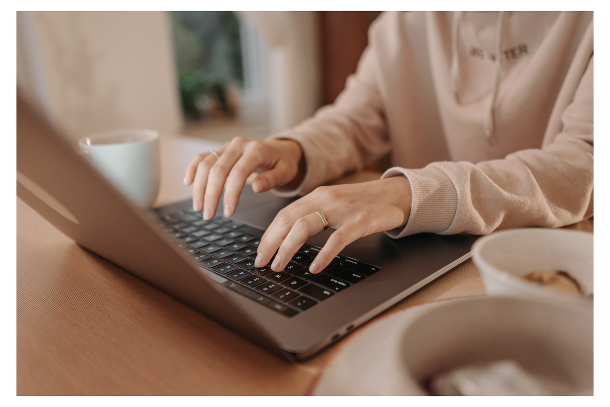 A Person Typing on a Laptop